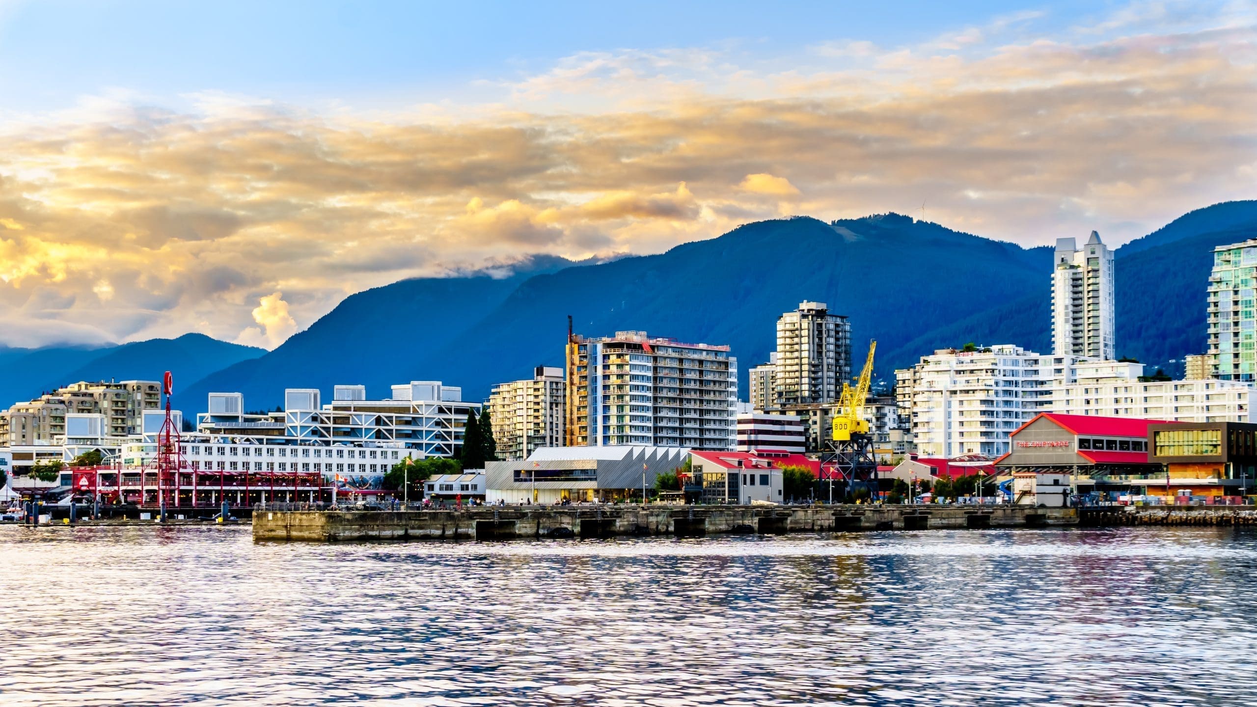Scenic view of Lonsdale Quay, shipyard, ocean, and high-rises in North Vancouver, highlighting the diverse real estate managed by Vancouver Property Management VPM Group RE/MAX, North Vancouver Property Management